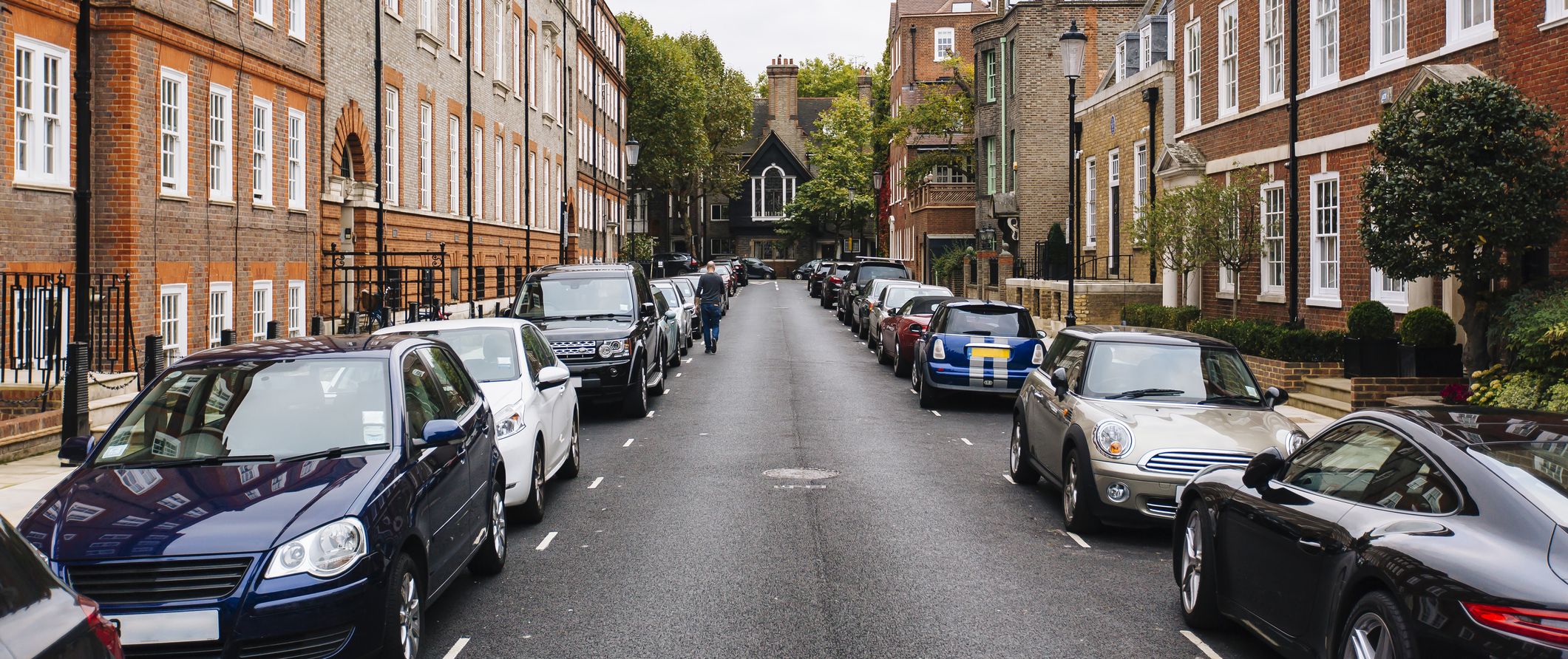 Street with parked cars in Kensington and Chelsea district, London, England, UK