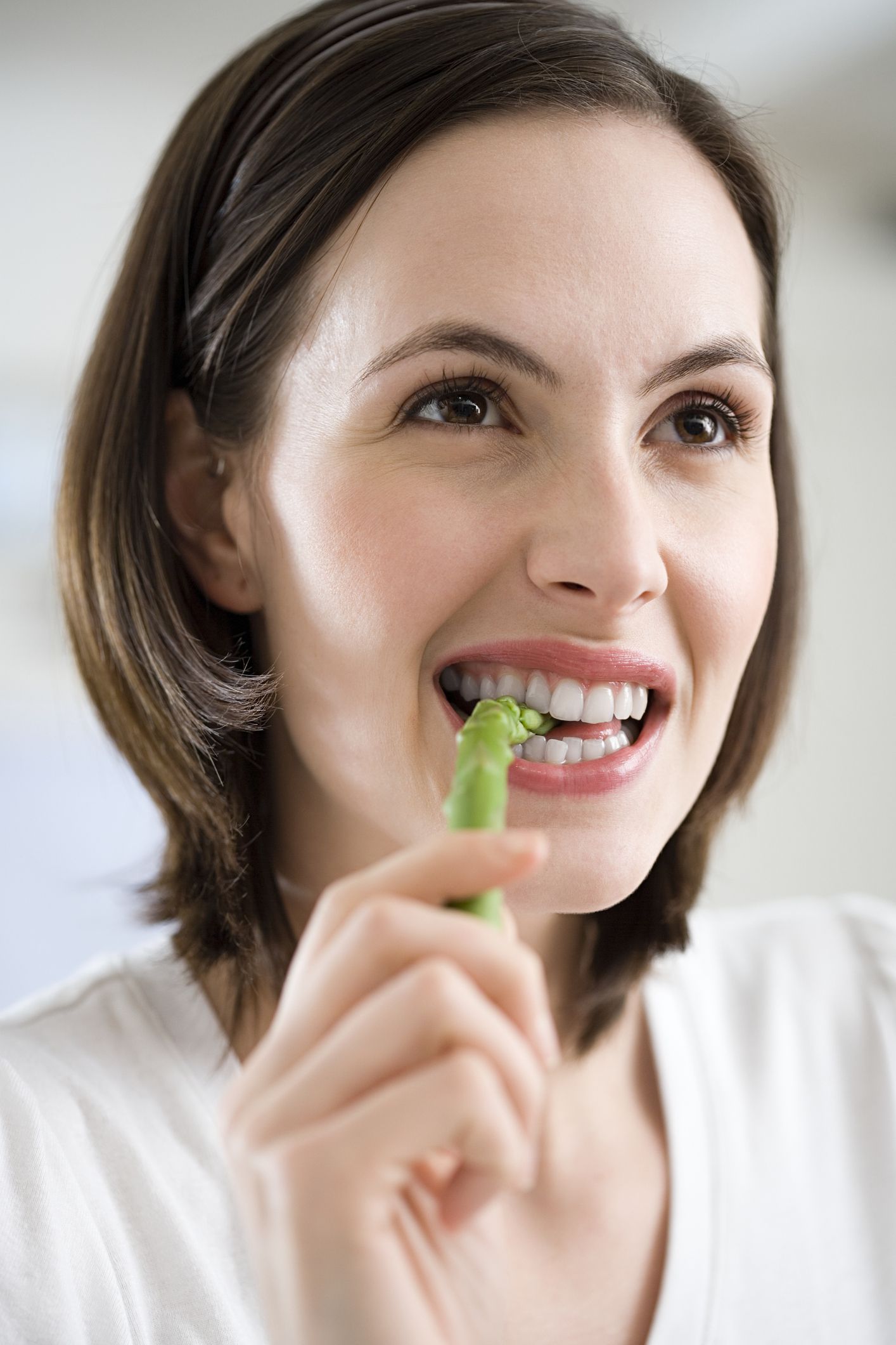 Woman eating asparagus Woman eating asparagus