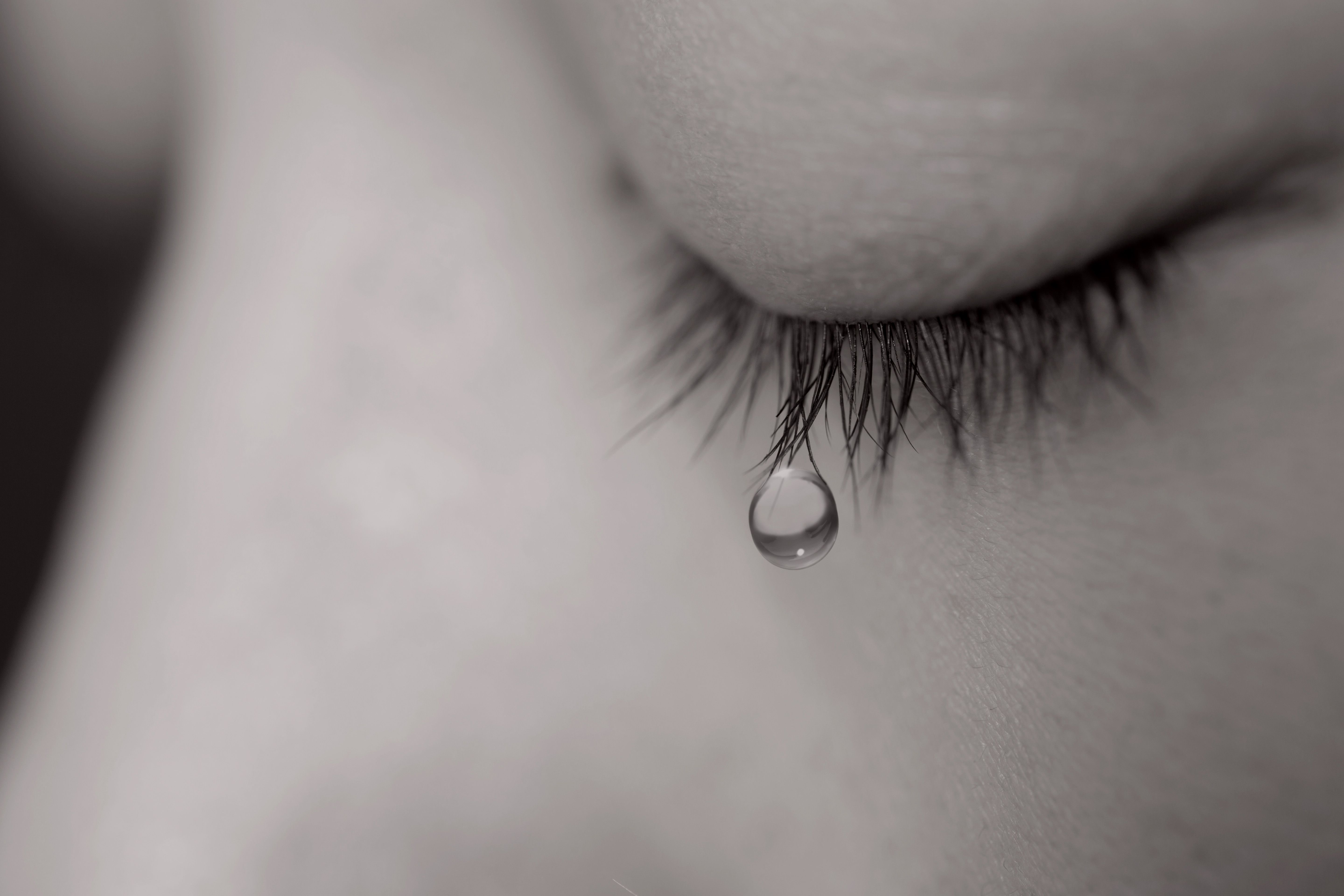 Young woman crying with tear drop